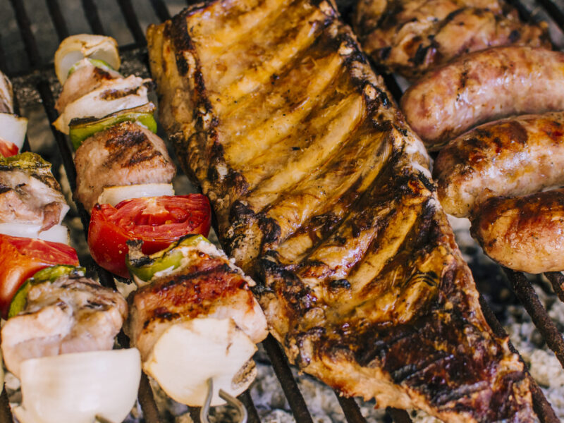 well grilled meat pieces and vegetables on grill charcoal